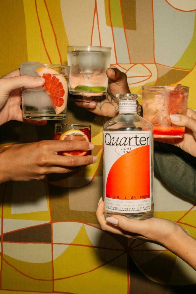 Bottle shot of Quarter Gin with cocktails