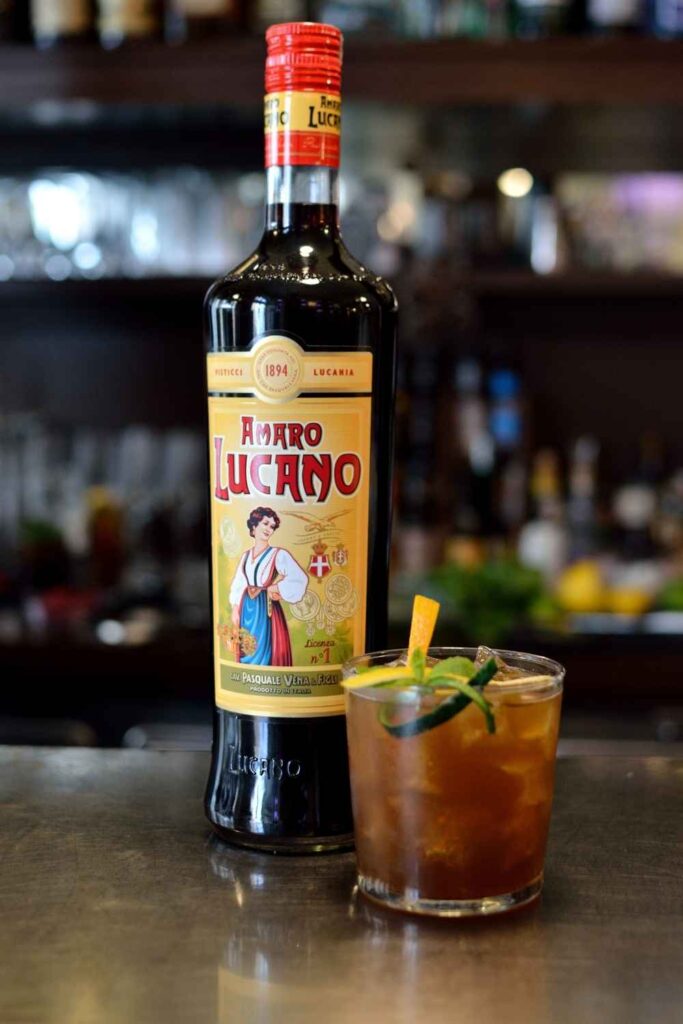 Amaro Lucano bottle with the Lucano cup cocktail